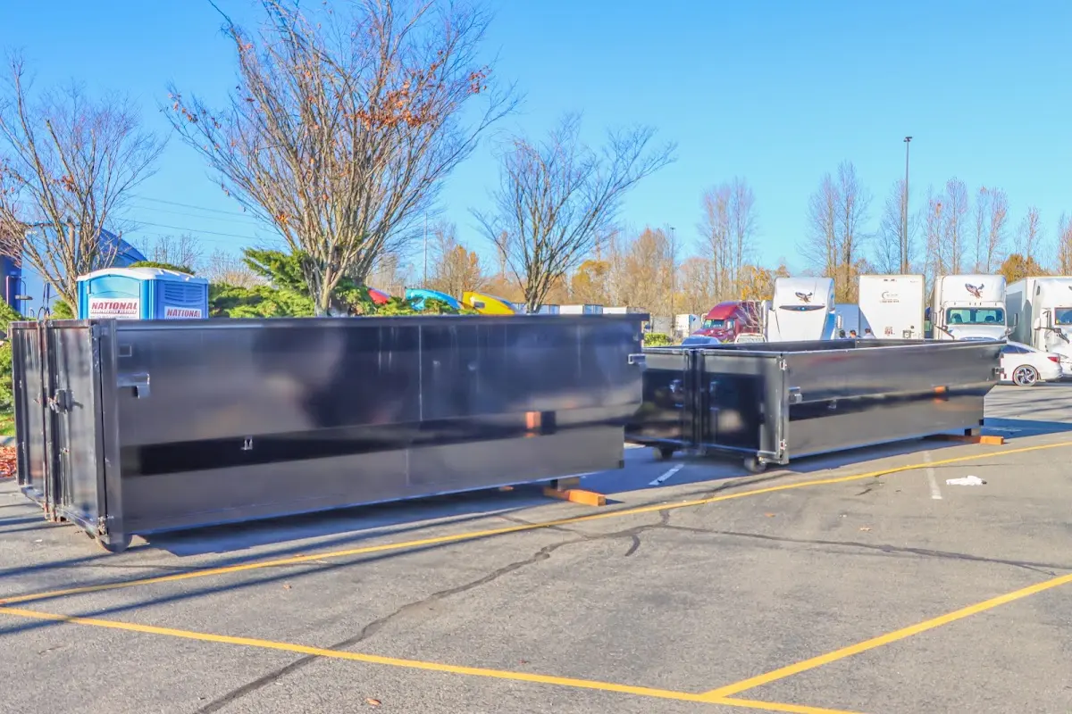 Professional dumpster rental service with roll-off container on residential driveway in Rehoboth